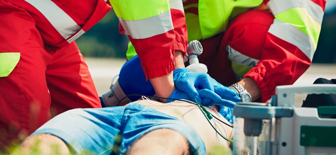 Two paramedics perform CPR on patient